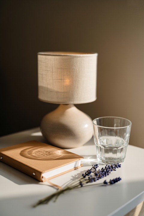 A tidy bedside table with a notebook