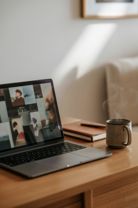 A laptop on a desk, a blog of photos on the screen
